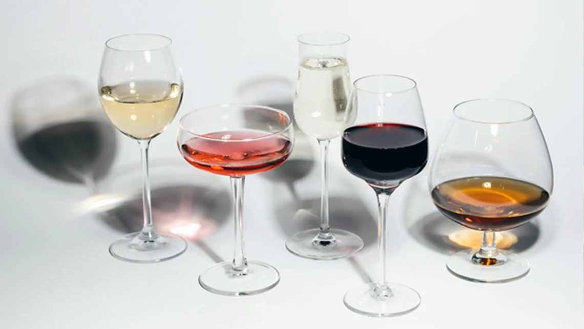 5 wine glasses with various non-alcoholic drinks for Dry January