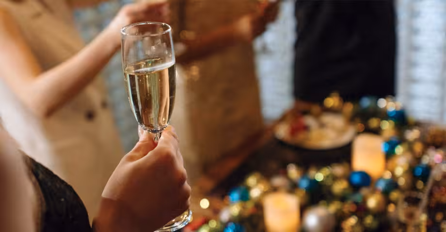 close-up photo of a woman’s against a backdrop of New Year ornaments